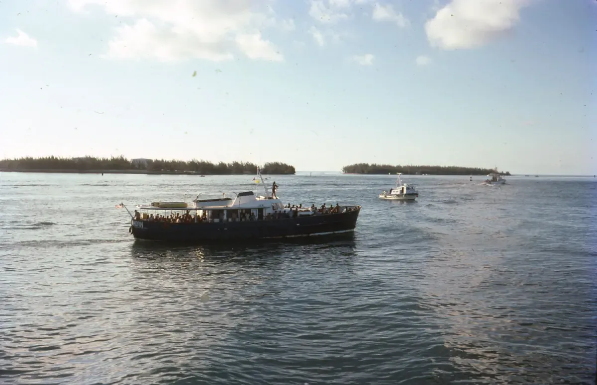 A crowded boat carrying Cuban refugees arrives in Key West harbour, with other boats behind it